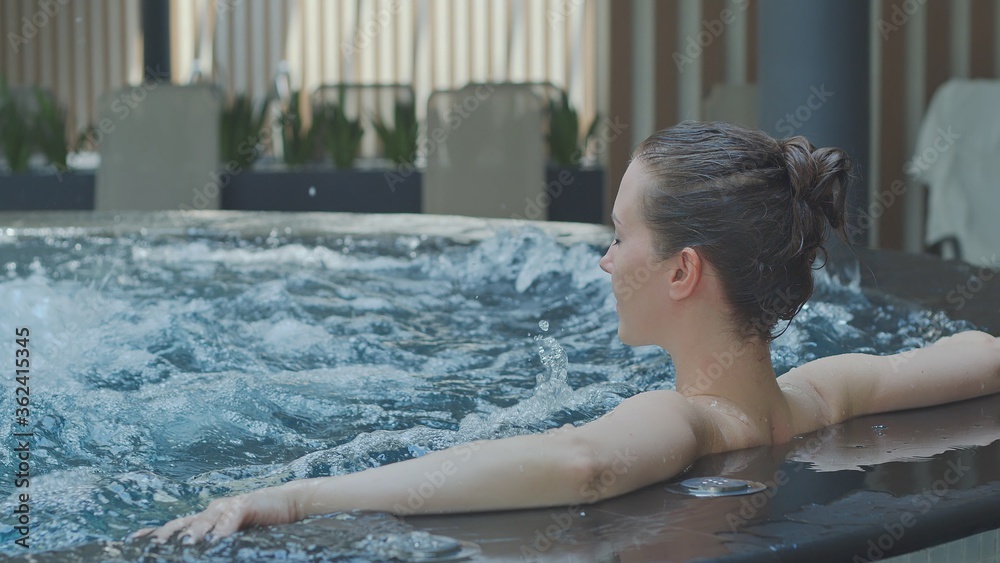 Woman relaxing in hot tube, Resting in whirlpool water in wellness spa resort. Woman relaxing in hot tube, Resting in whirlpool water in wellness spa resort.