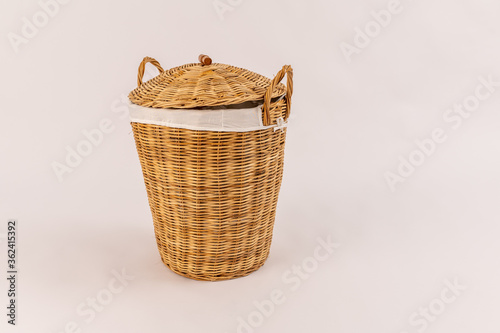 Clothes in a laundry wooden basket isolated on white background