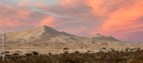 Incredible scenic desert landscape featuring giant sand dunes and a colorful sunset. Photographed at Kelso Dunes in Mojave Desert National Preserve