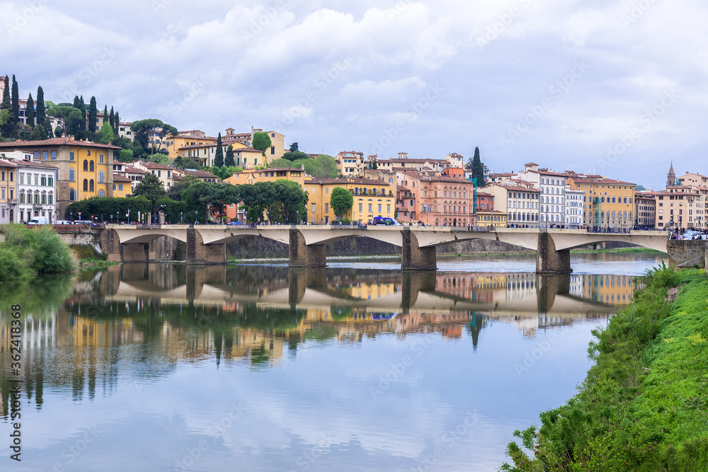 Florence or Firenze, Ponte delle Grazie bridge, landmark on Arno river, landscape with reflections on the water. Tuscany, Italy. 