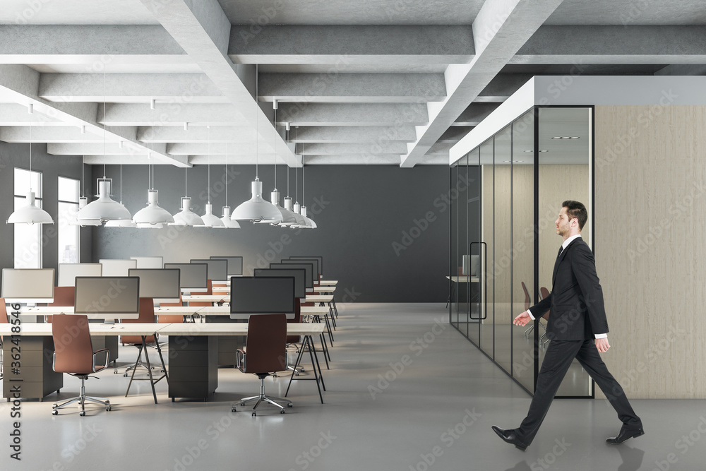Businessman walking in contemporary office interior Businessman walking in contemporary office interior