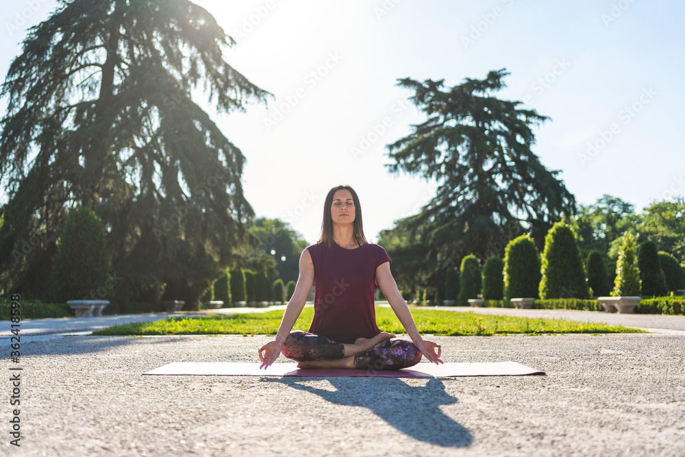 Spanish Woman Doing yoga Outdoors. Yoga Concept.