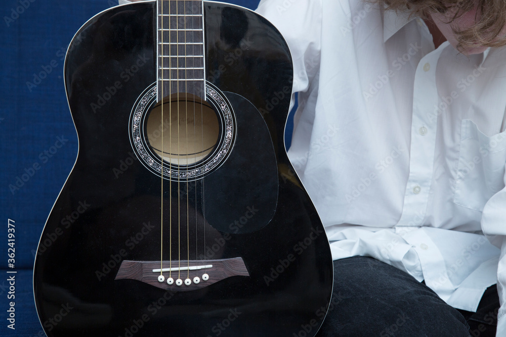 Fototapeta premium Playing guitar. A man plays the guitar. Close up.