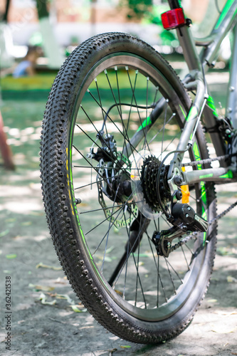 Closeup of the bicycle gear mechanism and chain on the rear wheel of a folding bicycle, blurry background