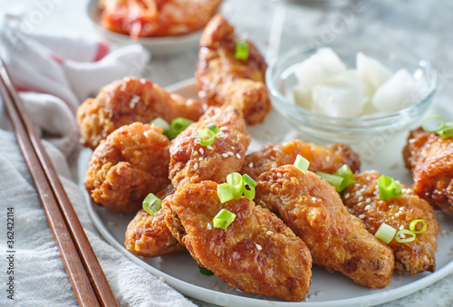 korean fried chicken wings with pickled radish and kimchi
