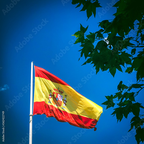 Spanish flag waving in a dark blue sky photo