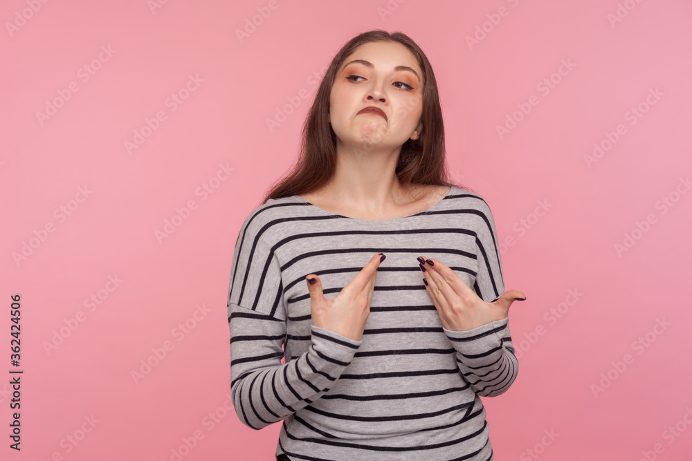 I'm the best! Portrait of arrogant egoistic woman in striped sweatshirt pointing herself and looking supercilious selfish, feeling self-important, proud of achievement. indoor studio shot isolated I'm the best! Portrait of arrogant egoistic woman in striped sweatshirt pointing herself and looking supercilious selfish, feeling self-important, proud of achievement. indoor studio shot isolated
