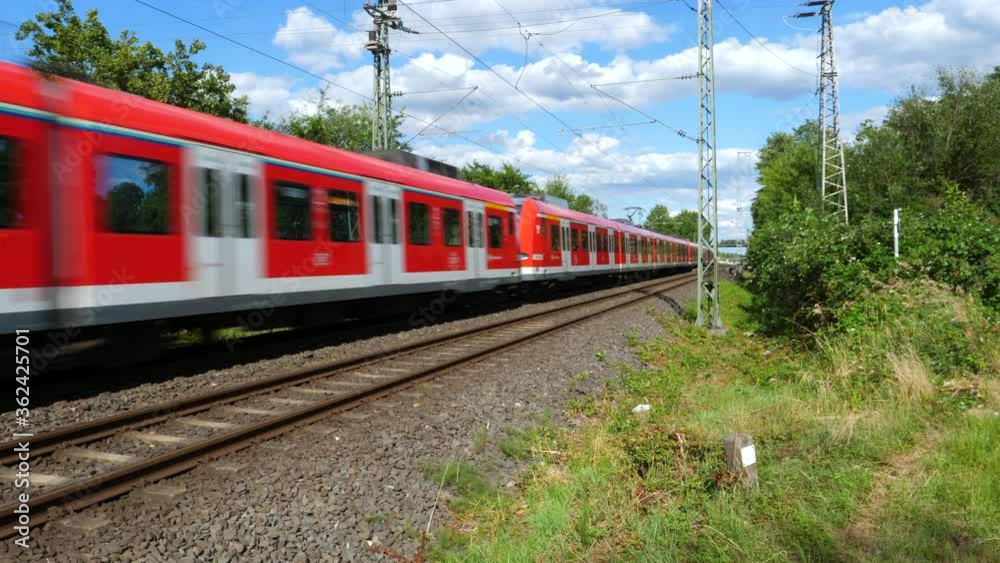 Frankfurt, Germany - July 03, 2020: A passing German S-Bahn nearby Frankfurt-Roedelheim. S-Bahn is a combined city center and suburban railway system metro in Germany.