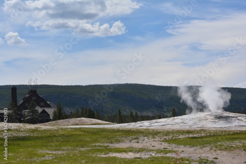 Old Faithful Inn behind Old Faithful Geyser - Yellowstone National Park 