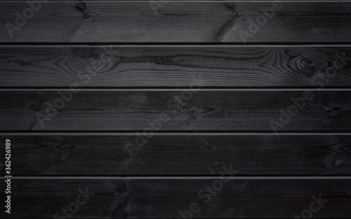 The texture of painted ebony. Black wood planks horizontally