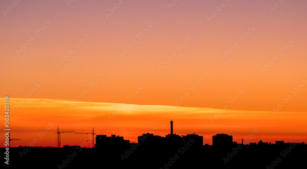 Silhouette panorama at sunset with building and cranes. Vladimir city, Russia
