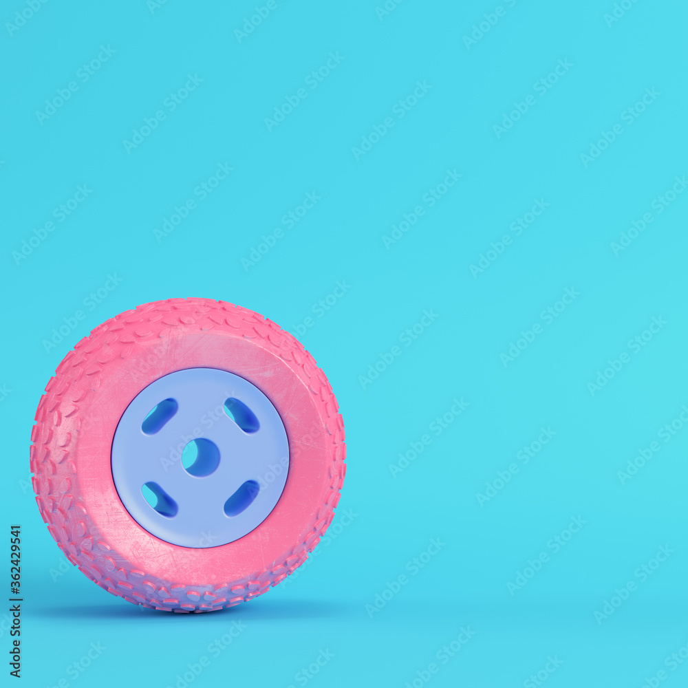 Pink car wheel on bright blue background in pastel colors. Minimalism concept Pink car wheel on bright blue background in pastel colors. Minimalism concept
