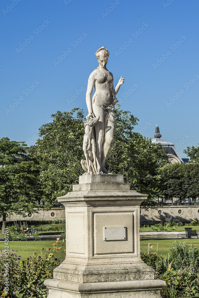 Ancient sculpture in Jardin des Tuileries (Tuileries garden) - favorite spot for rest of tourists and Parisians. Garden created by Catherine de Medici in 1564. Paris, France.