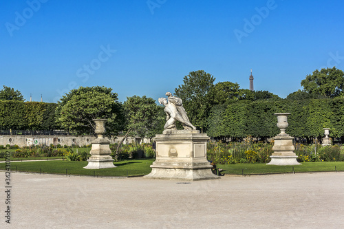 Ancient sculpture in Jardin des Tuileries (Tuileries garden) - favorite spot for rest of tourists and Parisians. Garden created by Catherine de Medici in 1564. Paris, France.