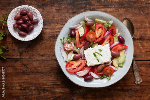 A fresh traditional greek salad horiatiki choriatiki with feta cheese, tomatoes, cucumber, onion and kalamata olives