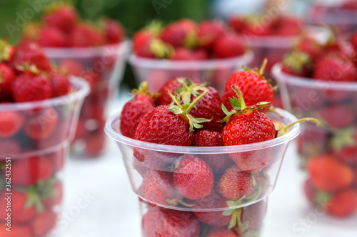 Fresh strawberries in a plastic Cup