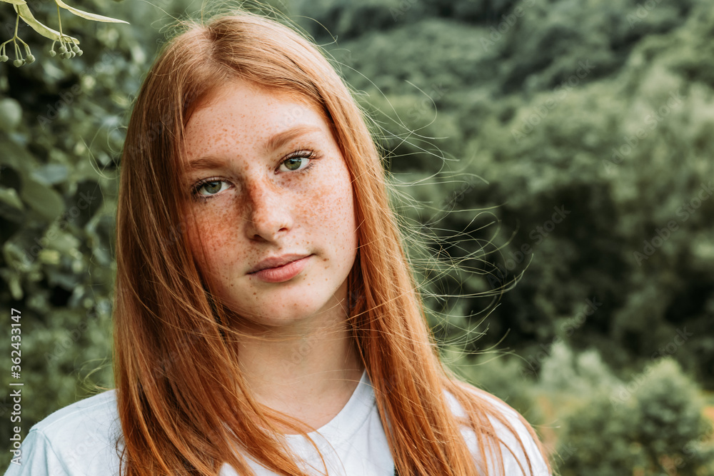 Close-up portrait of young teen freckled ginger girl