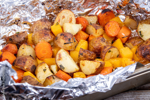 Roasted vegetables with herb on foil