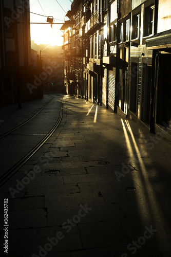 Narrow streets of the old city in the rays of a stunning dawn. Porto, Portugal.