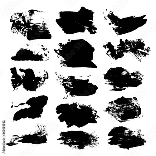 Abstract black ink textured brush strokes isolated on a white background