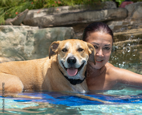 Youthful Asian woman in pool with pool enjoying summer.