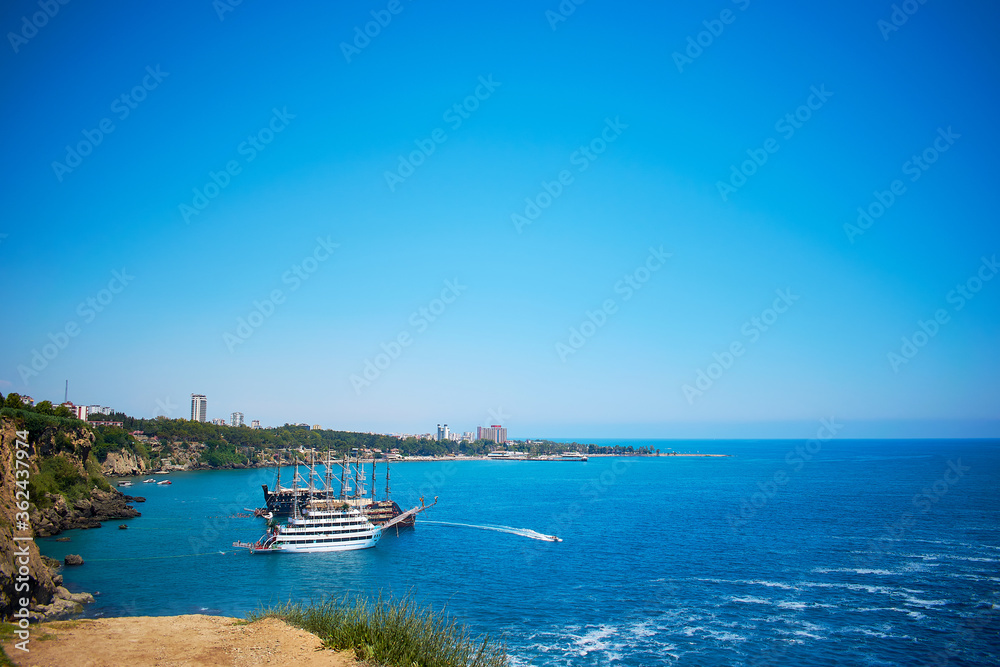 Seascape, beautiful spacious view of the sea and rocks. Two cruise ships, top view. Lower Duden waterfall in Antalya.
