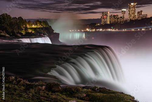 Long exposure of Niagara Falls in evening, illuminated with white light from Canadian side, Buffalo NY 