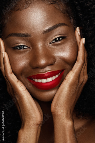 Beauty fashion portrait of African American young woman. Close up photo of Beautiful model with curly hair and perfect skin