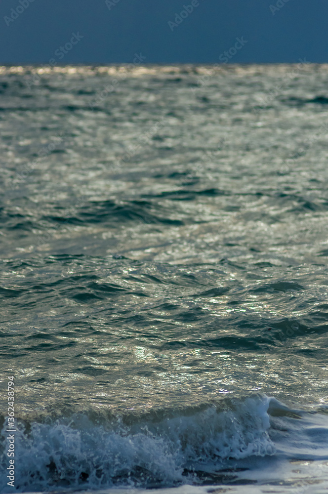 Obraz premium sea landscape is a pebbly beach with waves in white foam