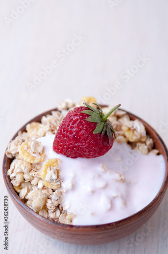 Clay Cup with muesli, yogurt and strawberries, place for text