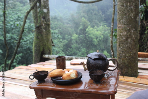 Tea set in the forest. Warm tea on the mountain