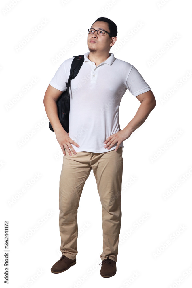 Young Asian male student wearing glasses looking up and thinking while holding backpack. Full body portrait Young Asian male student wearing glasses looking up and thinking while holding backpack. Full body portrait