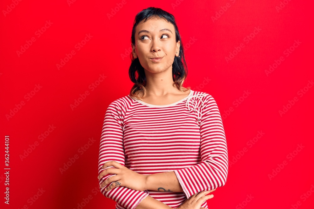 Young woman wearing casual clothes smiling looking to the side and staring away thinking. Young woman wearing casual clothes smiling looking to the side and staring away thinking.