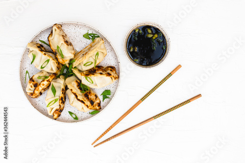 Asian dumplings with soy sauce and chopsticks