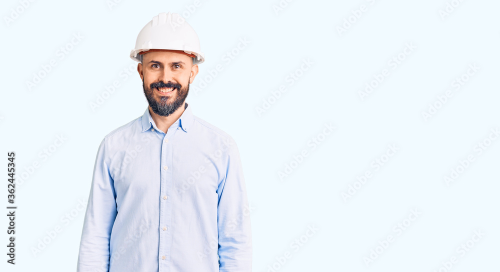 Young handsome man wearing architect hardhat with a happy and cool smile on face. lucky person. Young handsome man wearing architect hardhat with a happy and cool smile on face. lucky person.