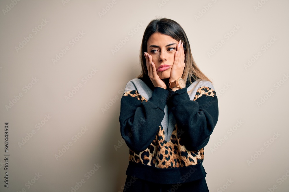 Young beautiful woman wearing casual sweatshirt standing over isolated white background Tired hands covering face, depression and sadness, upset and irritated for problem