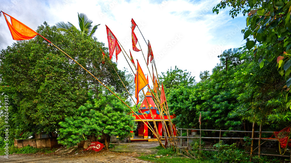 A small temple by the way side with festive colorful flags A small temple by the way side with festive colorful flags