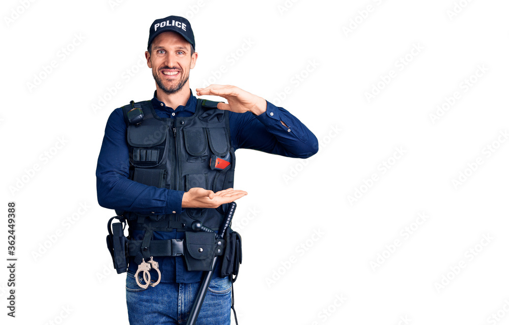 Young handsome man wearing police uniform gesturing with hands showing big and large size sign, measure symbol. smiling looking at the camera. measuring concept. Young handsome man wearing police uniform gesturing with hands showing big and large size sign, measure symbol. smiling looking at the camera. measuring concept.