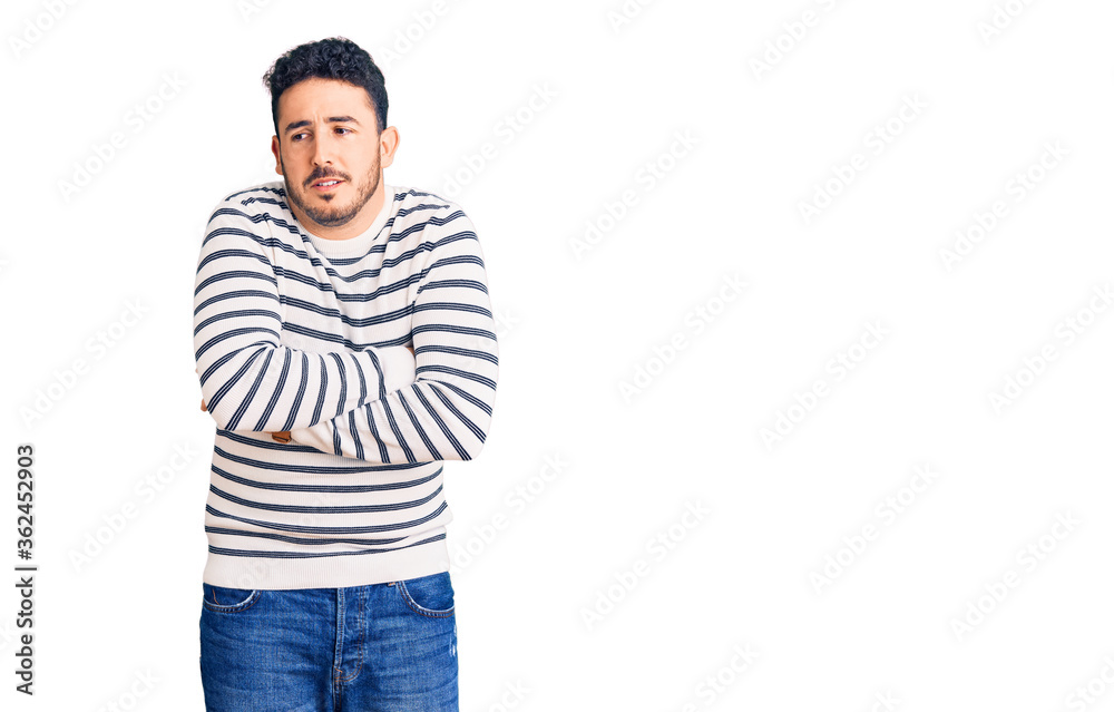 Young hispanic man wearing casual clothes shaking and freezing for winter cold with sad and shock expression on face Young hispanic man wearing casual clothes shaking and freezing for winter cold with sad and shock expression on face
