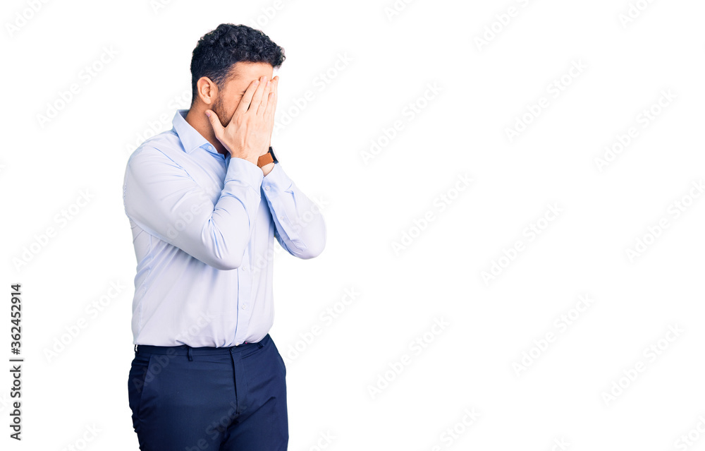 Young hispanic man wearing business clothes with sad expression covering face with hands while crying. depression concept. Young hispanic man wearing business clothes with sad expression covering face with hands while crying. depression concept.
