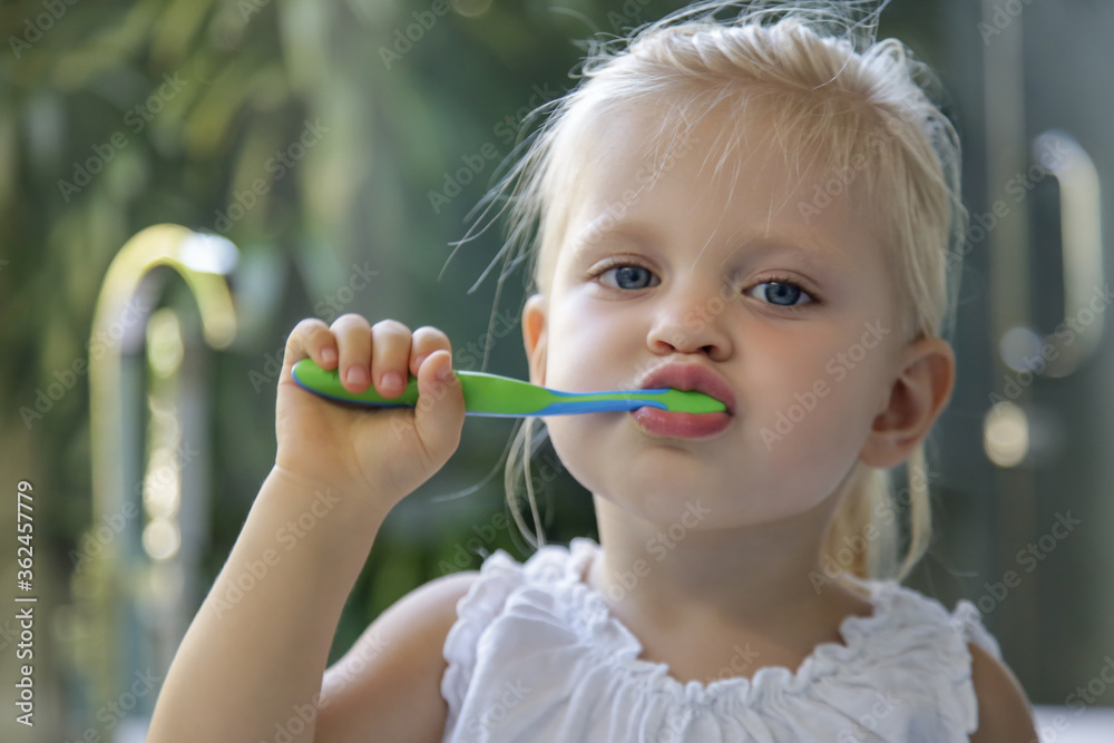 Adorable 3 years old girl brushing her teeth in bathroom. Adorable 3 years old girl brushing her teeth in bathroom.
