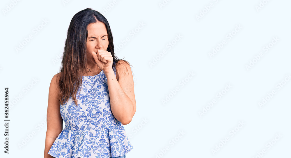 Young beautiful brunette woman wearing casual t-shirt feeling unwell and coughing as symptom for cold or bronchitis. health care concept. Young beautiful brunette woman wearing casual t-shirt feeling unwell and coughing as symptom for cold or bronchitis. health care concept.