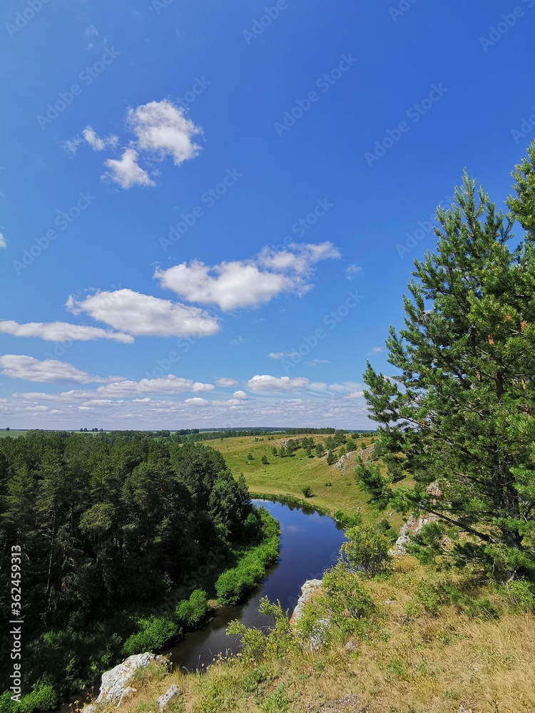 Obraz premium landscape with blue sky and clouds. Natural reserve in Sverdlovsk region, Russia. Manturov kamen, stone and rocks on river coast