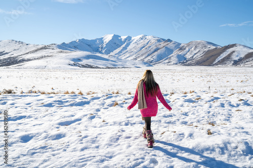 beautiful asian woman is relaxing in nature in winter in a beautiful location in New Zealand.