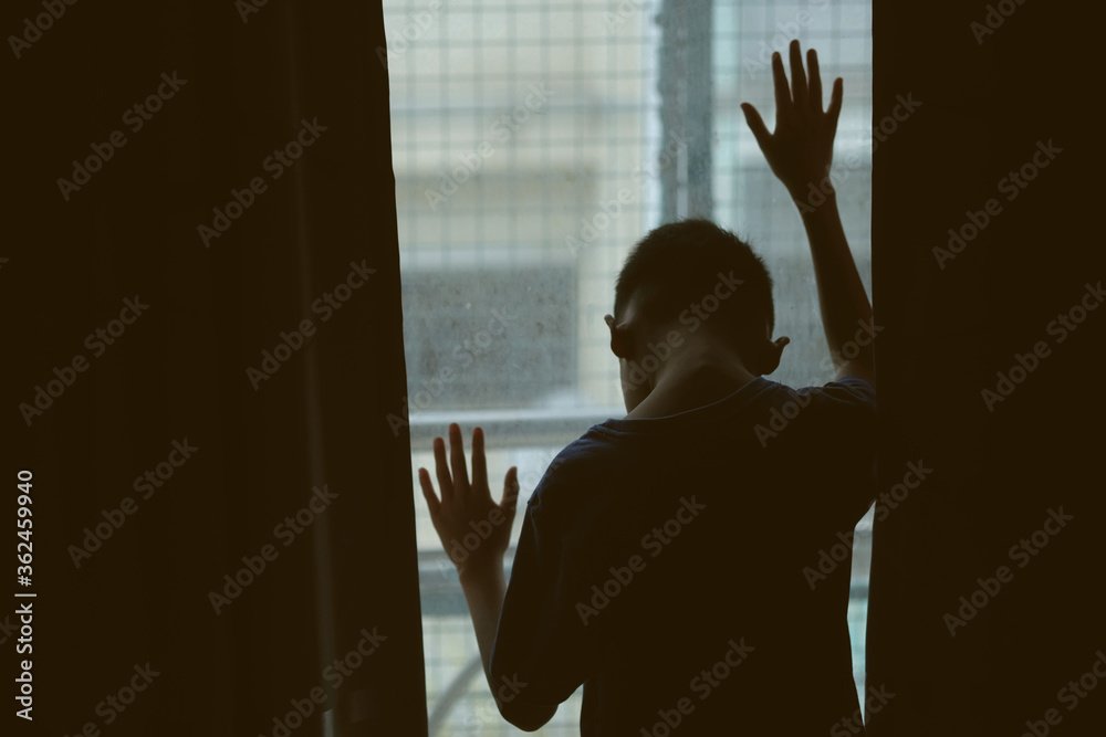 Asian boy looking out window at thailand