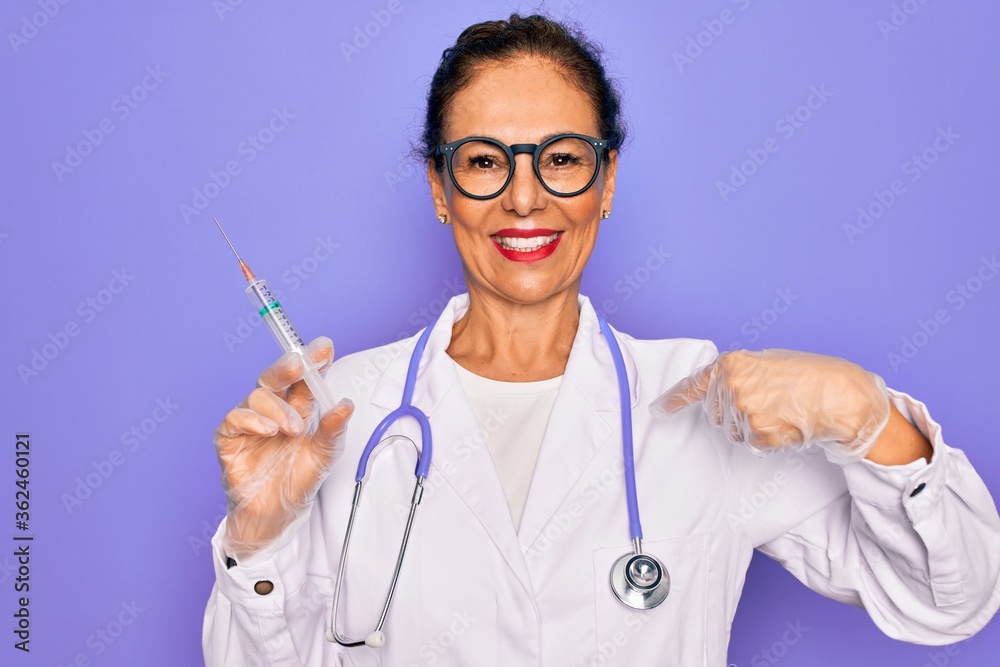 Middle age senior professional doctor woman holding syringe with medical vaccine with surprise face pointing finger to himself Middle age senior professional doctor woman holding syringe with medical vaccine with surprise face pointing finger to himself