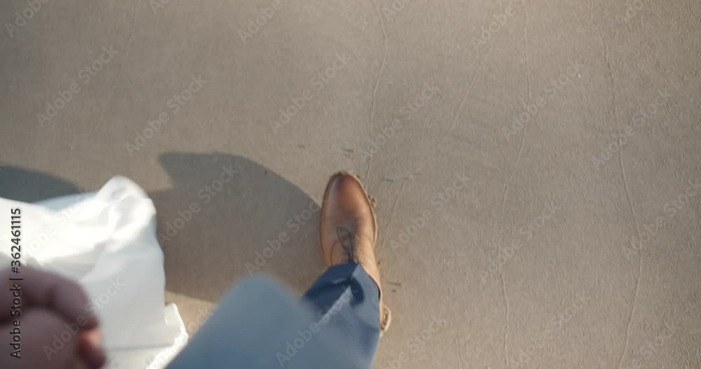 POV point of view Caucasian married couples feet on sandy beach in Hawaii. 