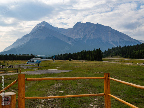 helicopter on the ground with a super tall mountain in the background