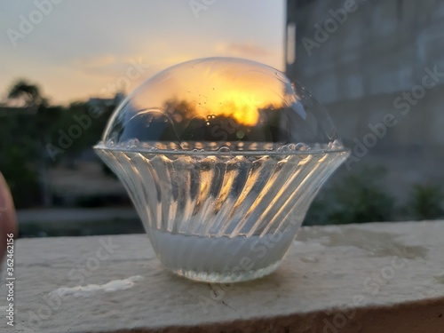 Sunset shot through a large water bubble 