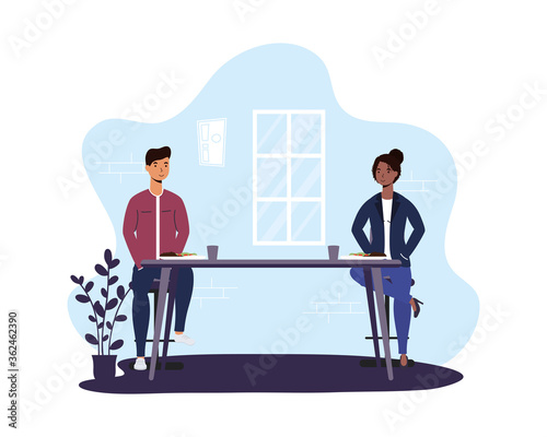 interracial couple dinning in restaurant practicing social distancing ,covid19 prevention method